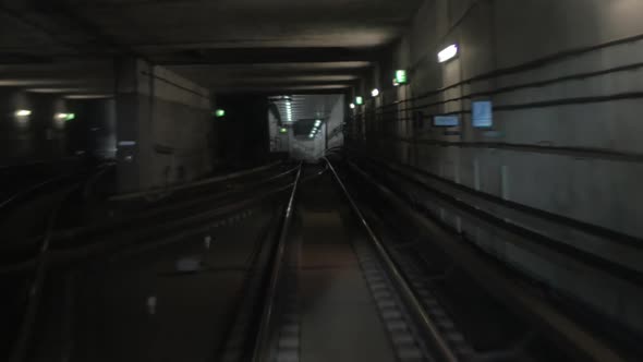 Subway train moving in tunnel and arriving to the station