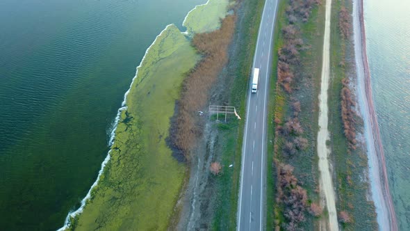 Aerial View of a Broken Billboard By a Road Next To the Sea