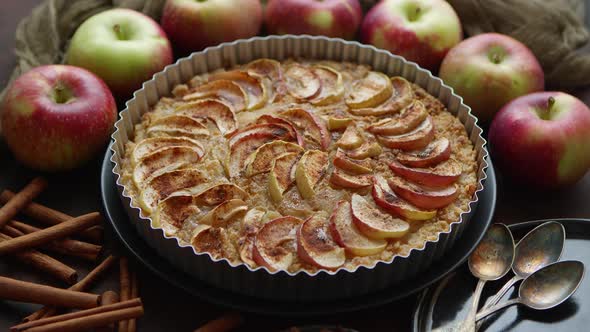 Homemade Apple Tart Pie with Fresh Fruits and Cinnamon Sticks on Rusty Background