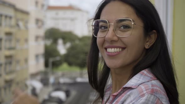 Happy Young Woman in Eyeglasses Looking at Camera