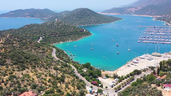 Aerial drone of a peninsula full of green hills and tropical turquoise blue water overlooking the Me