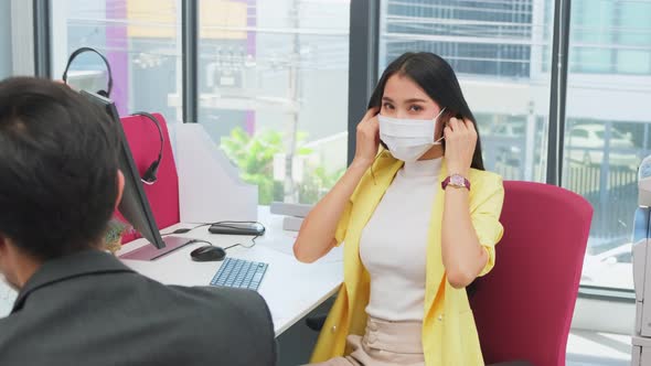 Portrait of business woman wear mask, working in office with new normal social distancing lifestyle.