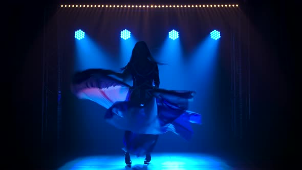 Silhouette Slender High Girl Dancing in a Sexy Suit in the Color of the English Flag and Rhinestones