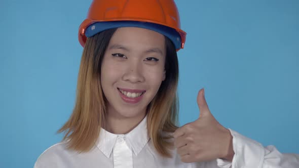 Beautiful Korean Happy Builder Showing Gesture Thumb Up