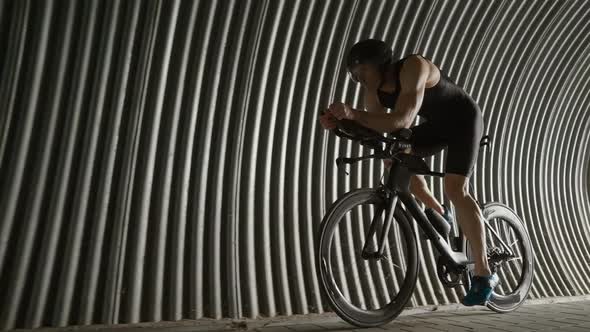 Pro Rider Rides a Cutting Bike Cyclist Rides in a Tunnel Athlete Training for Race  Slow Motion