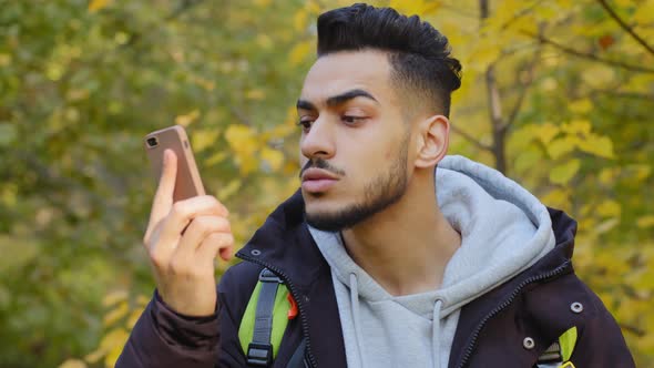 Young Man Standing Outdoors Lagged Behind Tourist Group Lost in Wood Traveling with Backpack