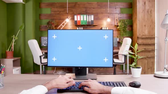 POV of Man Typing on Mockup PC in Modern Workplace