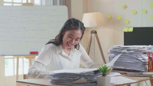 Asian Woman Working With Documents At The Office