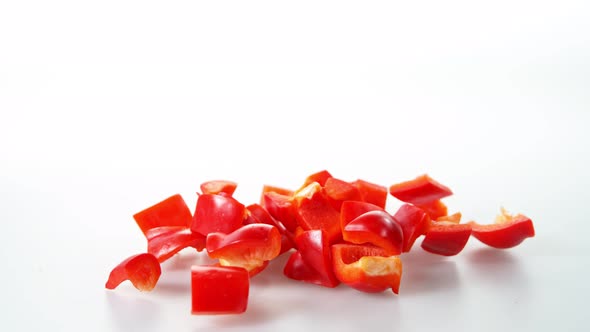 Super Slow Motion Shot of Falling and Slicing Red Pepper on White Background at 1000Fps