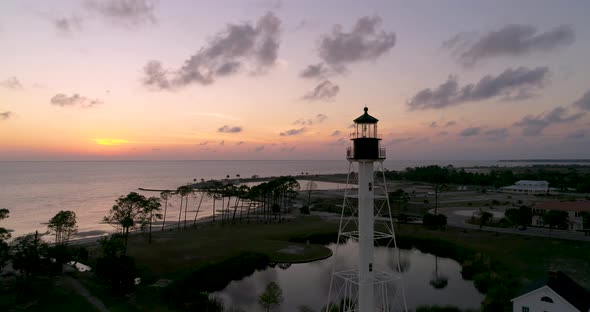 Aerial flight around a lighthouse during beautiful sunset