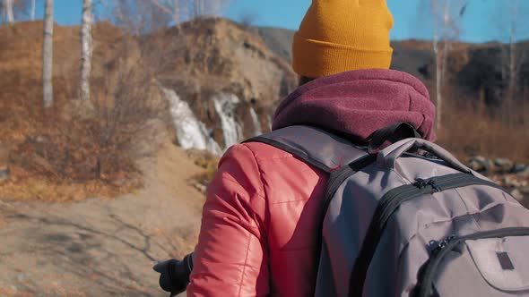 Woman Walks to Shoot Waterfall