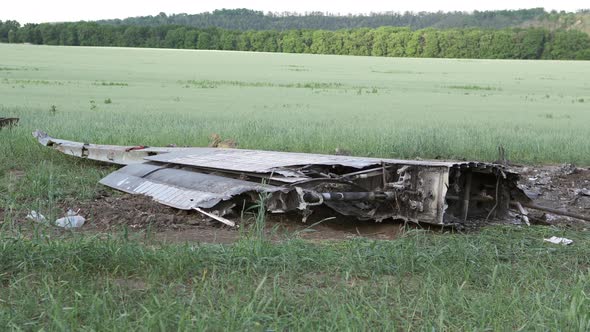 Downed military transport aircraft in a wheat field. Russian aggression in Ukraine.