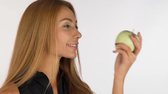 Attractive Young Woman Smelling Delicious Green Apple, Smiling Cheerfully 1080p