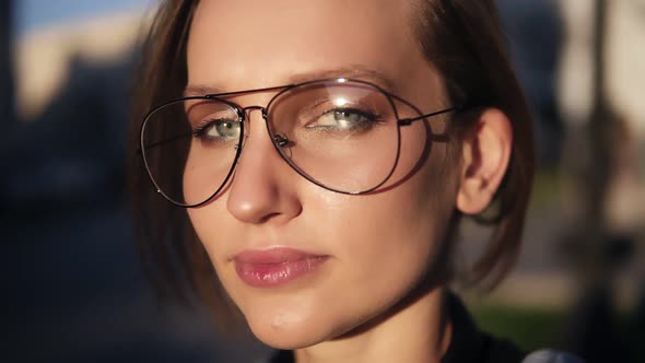 Fair Hair Woman in Transparent Modern Glasses Walking on the Street on a Sunny Day