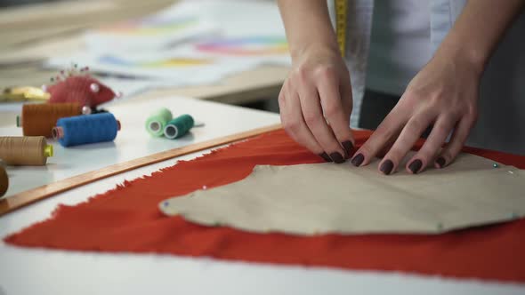 Rookie Tailor Ineptly Attaching Pattern to Fabric, Practice at Sewing Enterprise