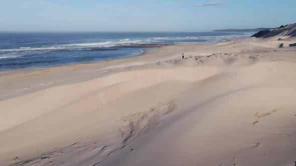 Drone Flying Over Woman Thats Walking Along Sand Dunes