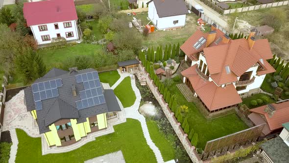 Aerial view of a rural private house with solar photovoltaic panels for producing clean electricity