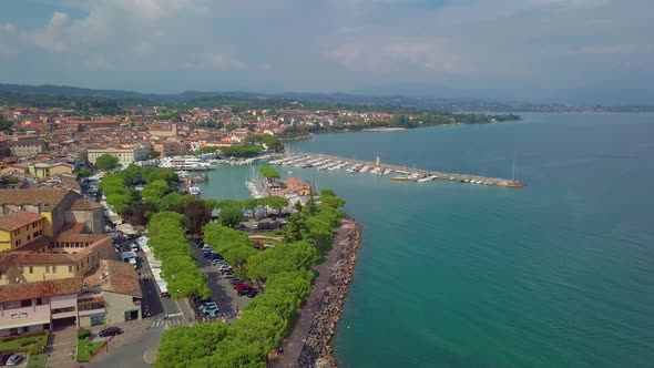 Aerial View of Boats and Coast of Lake Garda, Italy. Flying Over Boats and Shoreline of Lago Di