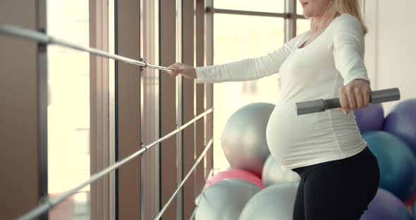 A Pregnant Woman Doing Bicep Muscle Exercises