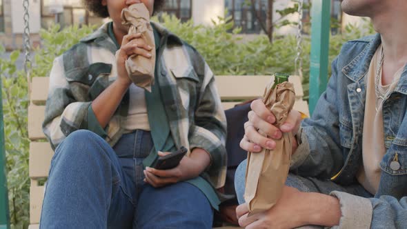 Friends Drinking from Bottles in Paper Bags