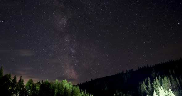 Clouds Moving From The Starry Night Sky Under The Mountain