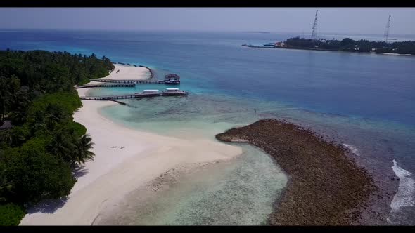 Aerial top down scenery of beautiful resort beach journey by blue green ocean with white sandy backg