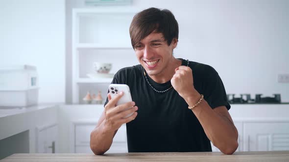 Excited Man Looking at Smartphone Celebrate Success Mobile Win Online Bet