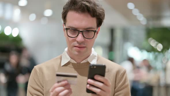 Man Making Online Shopping Payment on Smartphone