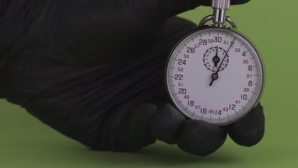 Mechanical Stopwatch Time in a Human Hand on a Green Screen
