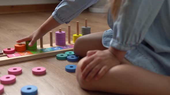 Happy Little Preschool Toothless Girl Playing With Colored Wooden Toy