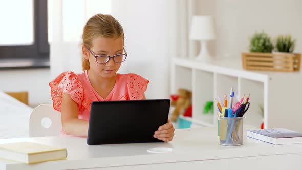 Student Girl Using Tablet Computer at Home