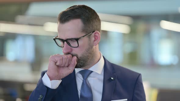 Portrait of Sick Middle Aged Businessman Coughing