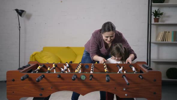 Happy Carefree Family Playing Table Soccer at Home