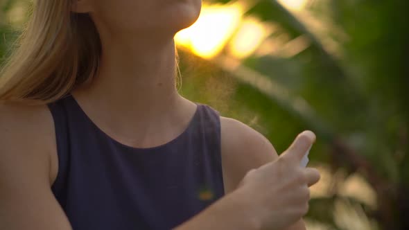 Superslowmotion Shot of a Beautiful Young Woman Applying an Antimosquito Repellent Spray on Her Skin