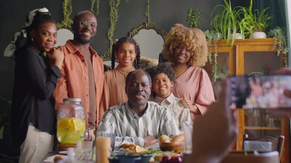 Happy African American Family Posing for Photo at Home Dinner