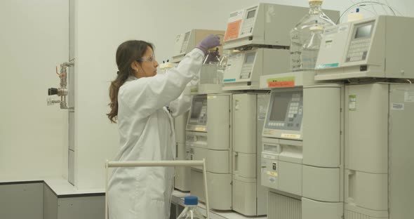 Scientist working with mass spectrometer in a pharmaceutical laboratory conducting experiments