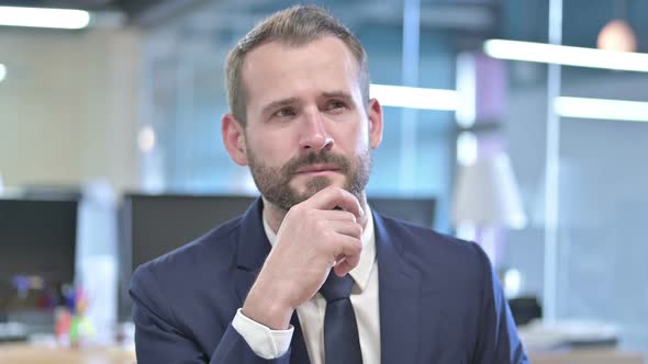 Portrait of Young Businessman Thinking and Get Idea