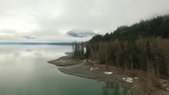 Aerial View of Canadian Mountain Landscape Covered in Fog Over Harrison Lake