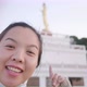 Close up of Asian woman standing and taking video selfie infront of monk statue - VideoHive Item for Sale