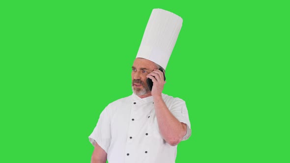 Concentrated Male Cook Making a Call on a Green Screen Chroma Key