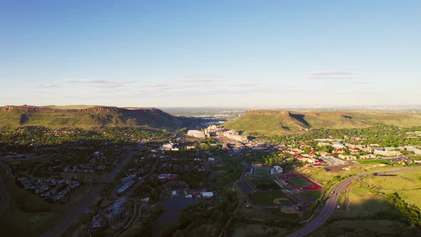 Drone Establishing Shot Of Small Denver City Limits Suburban Town Golden Colorado During Warm Golden