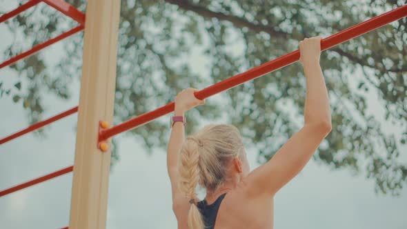 Fitness Sport Street Workout.Muscle Up In Public Gym.Woman On Pull-up Bars Exercising.