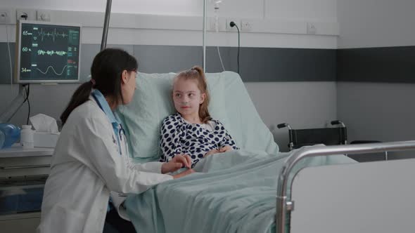 Pediatric Woman Doctor Interacting with Sick Patient Giving High Five During Clinical Consultation