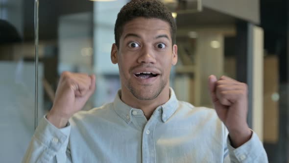 Excited Young African Man Celebrating Success