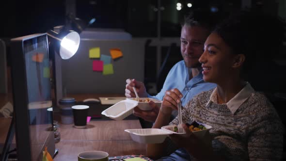 Office executives eating and discussing in a modern office