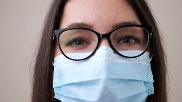 Doctor with Glasses and Protective Mask Smiles for Camera