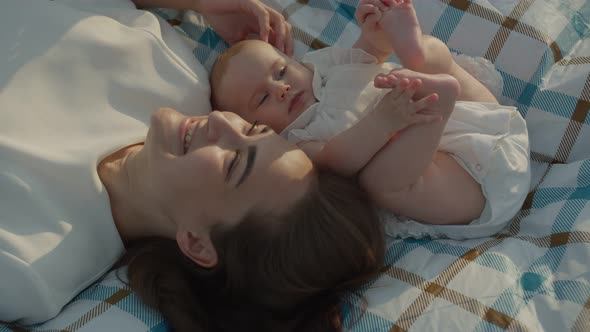 Mom with Little Daughter at a Picnic