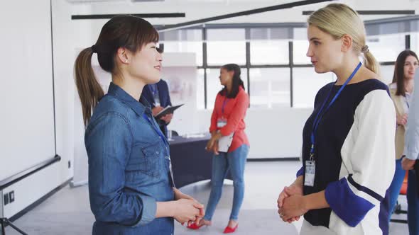 Businesswomen shaking hands in conference office