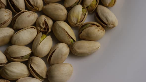 Cinematic, rotating shot of pistachios on a white surface - PISTACHIOS 005