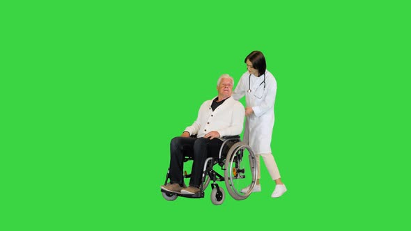 Nurse Pushing a Patient on a Wheelchair on a Green Screen Chroma Key